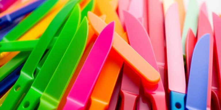 Colorful plastic knife blades in various shapes and sizes.